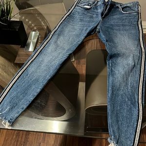 Womens blue jeans with beads on the side.